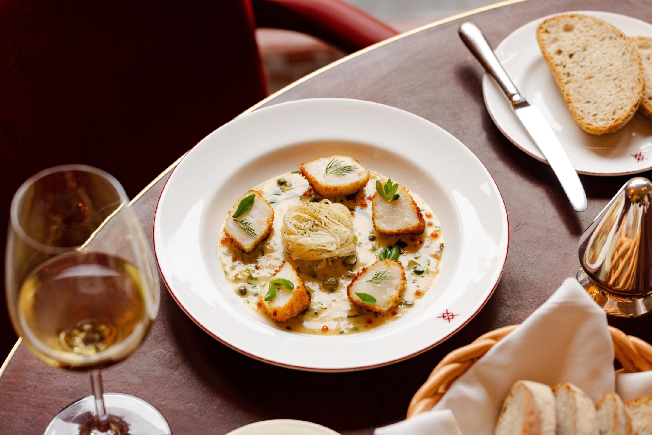 Orkney scallop scampi and warm tartare sauce, served for dinner on a white plate