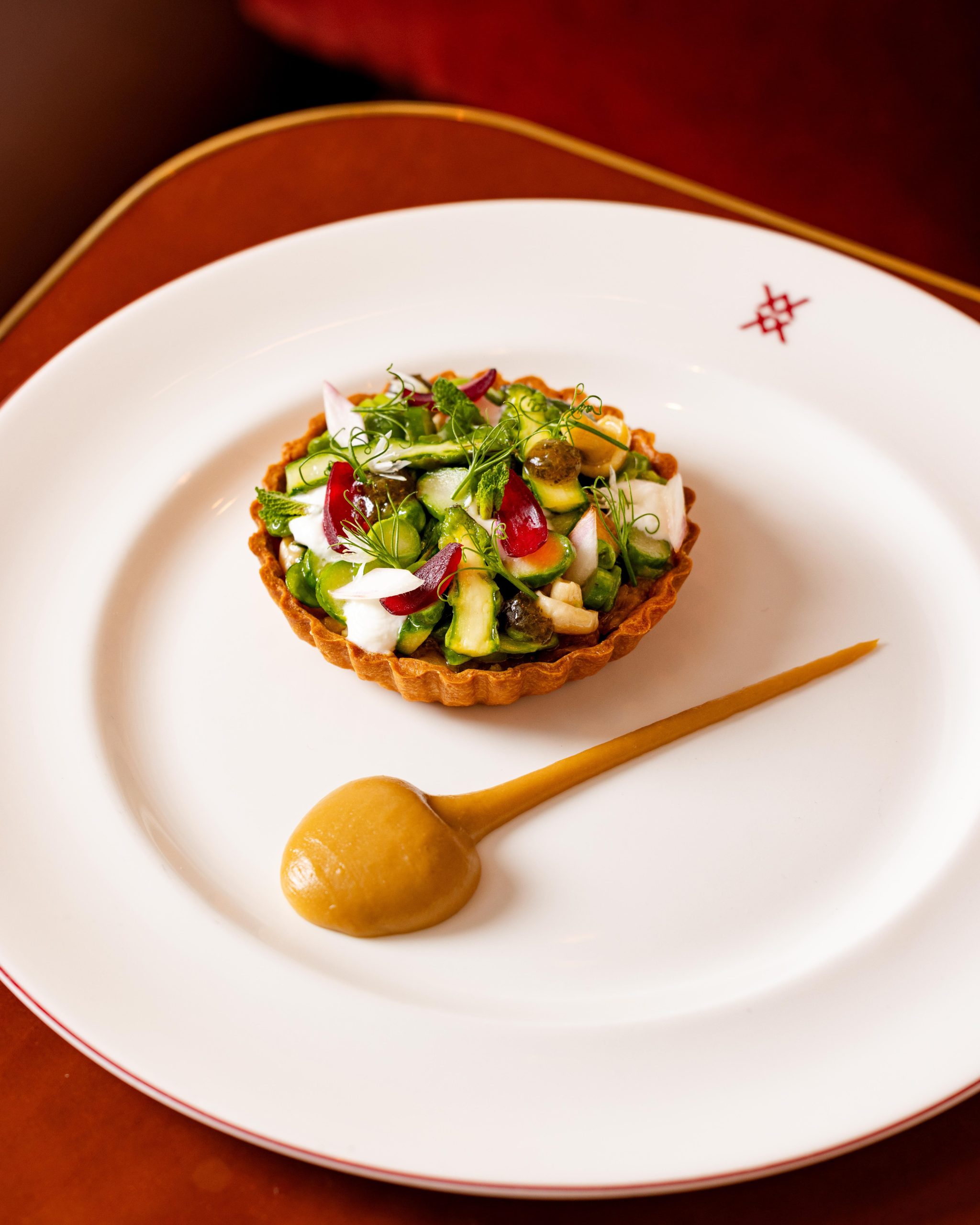 Tart of caramelised onions, goat’s curd & spring vegetables