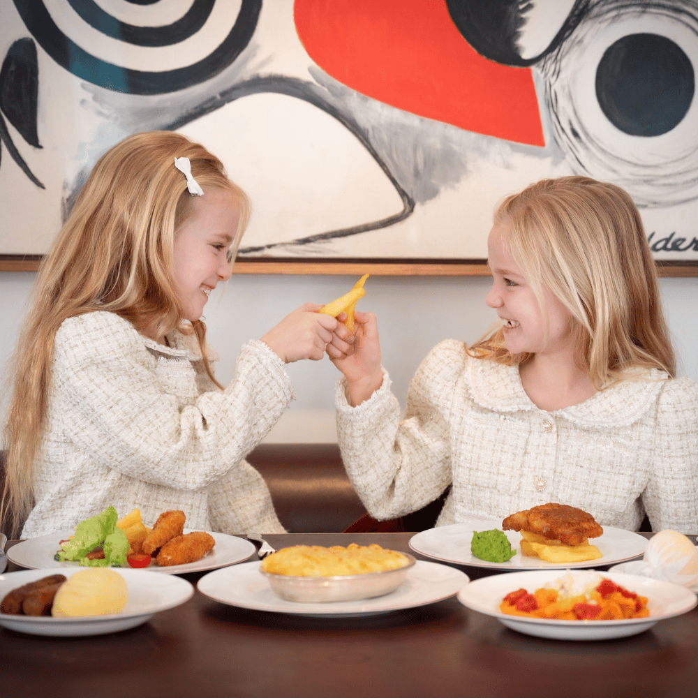 Two children enjoying food at Mount St. Restaurant