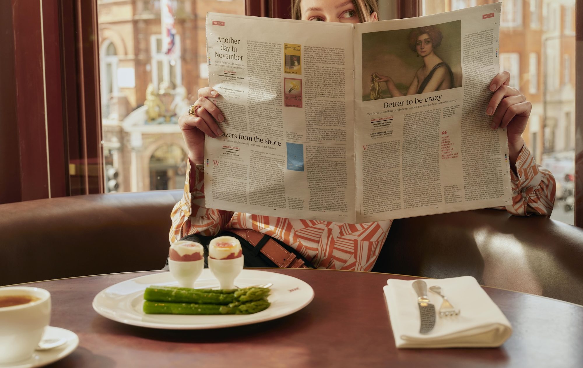 Lady reading a newspaper whilst enjoying breakfast at Mount St Restaurant