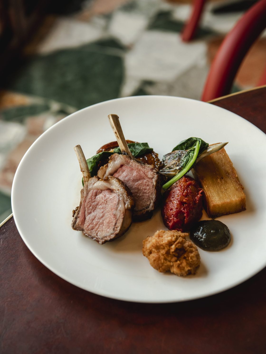 Durslade Farm lamb rack, belly, confit potato, artichoke & tomato fondue