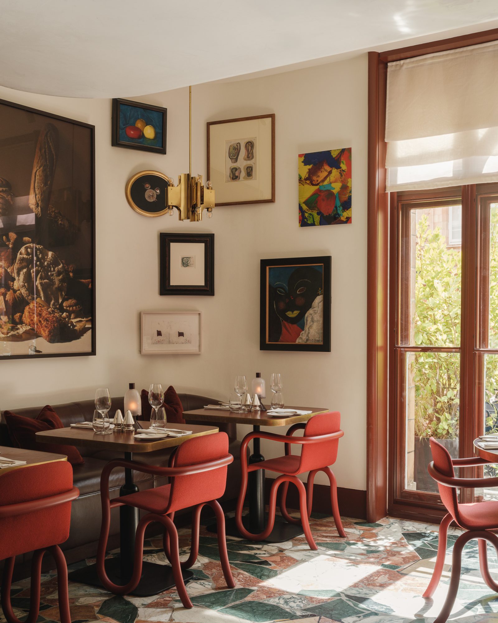 Mount St. Restaurant by day – a view of the restaurant with tables set and art in the background