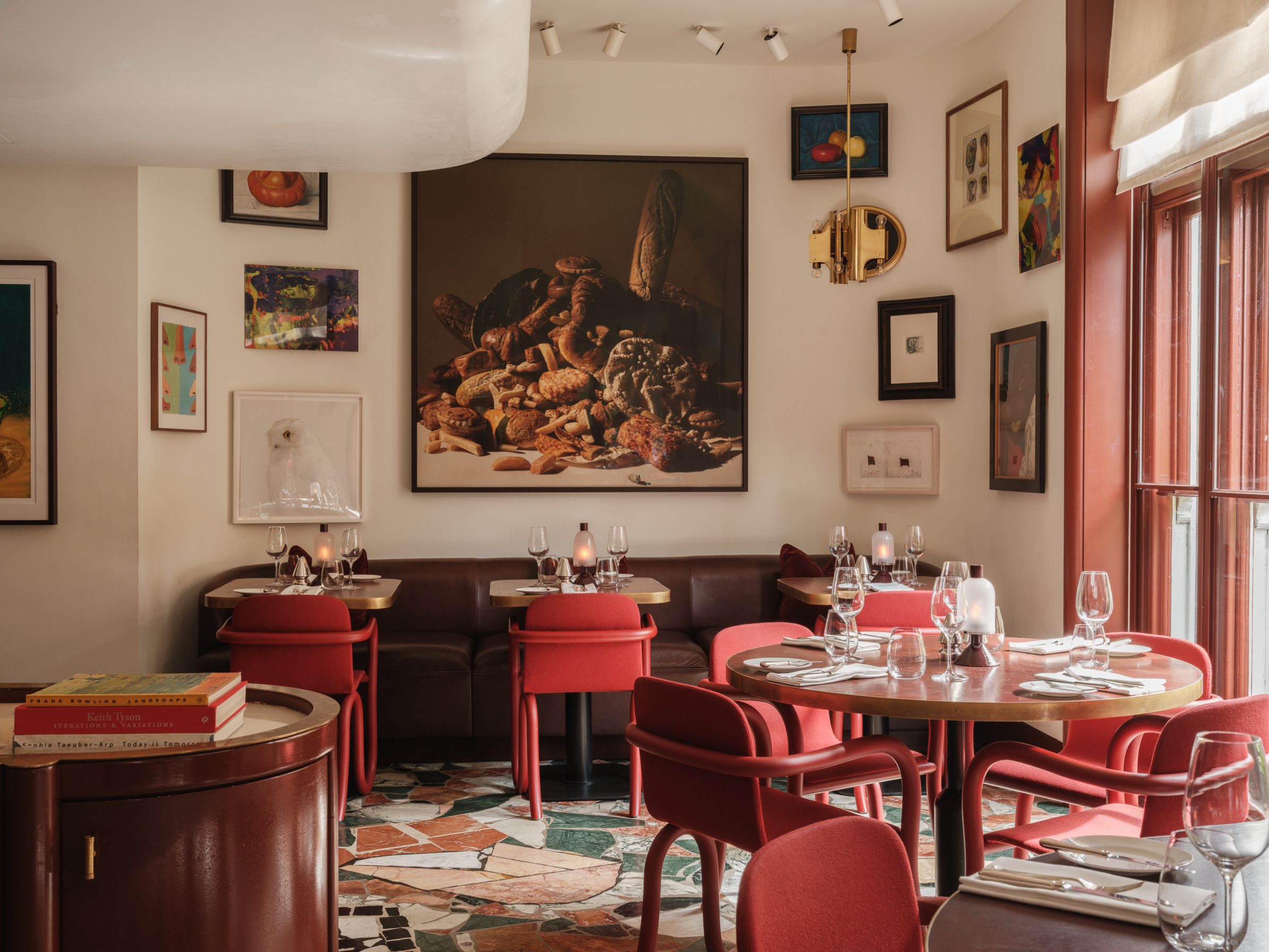 Mount St. Restaurant by day – a view of the restaurant with tables set and art in the background