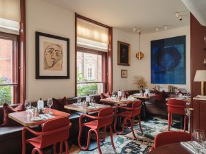 Mount St. Restaurant by day – a view of the restaurant with tables set and art in the background